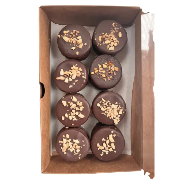 Caja abierta con 8 alfajores de chocolate semiamargo con lluvia de crocante de frutos secos de Enjoy y a Picar.